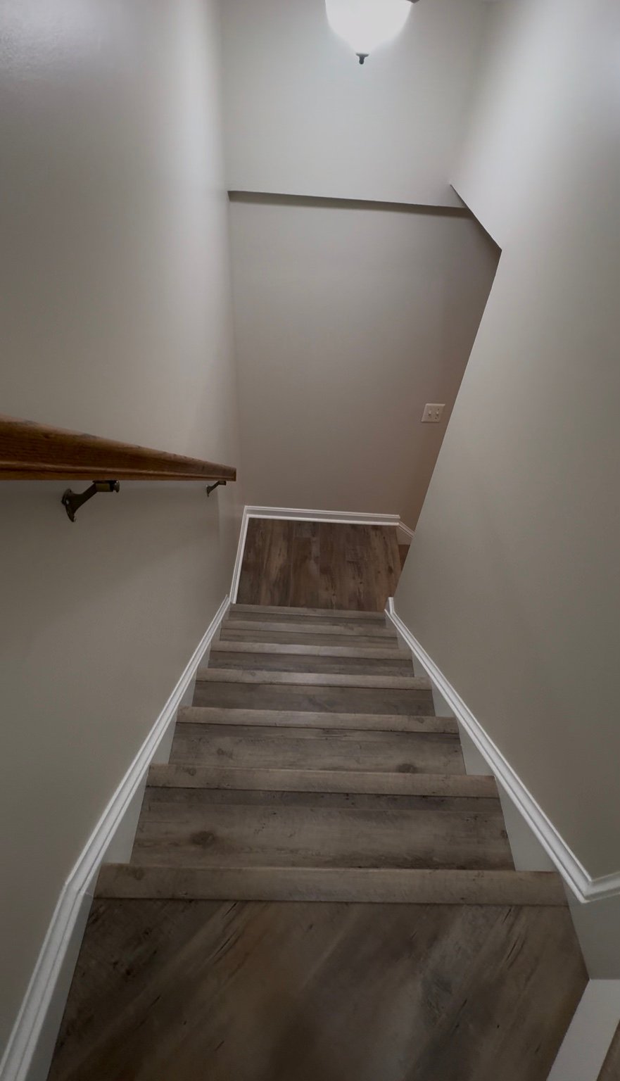 Basement stair remodeling with new flooring and trim installation in Arlington VA