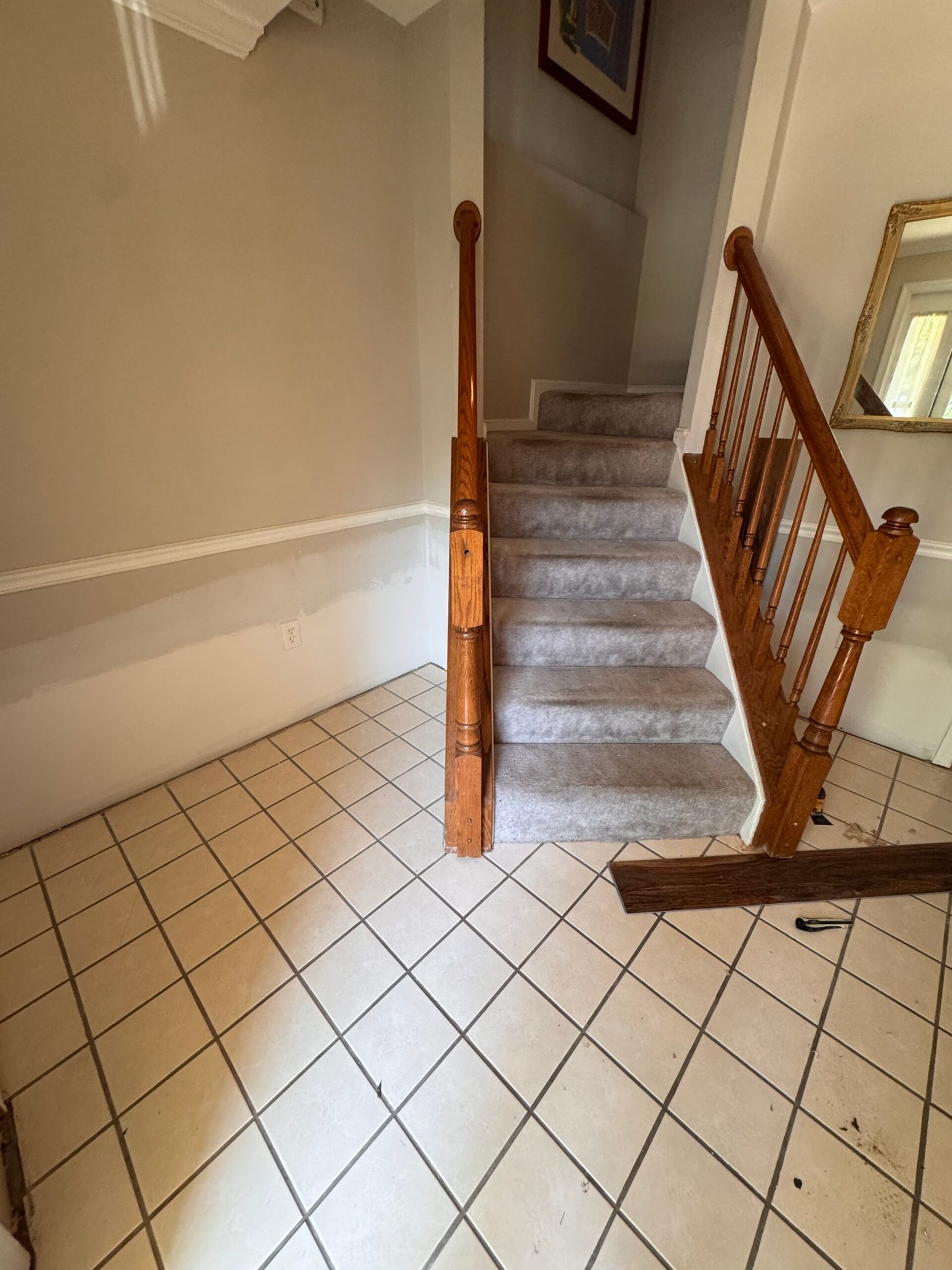 Staircase and main level before flooring replacement in Arlington, VA