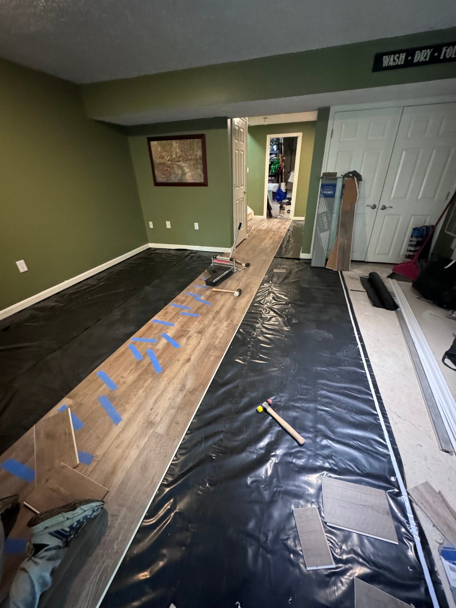 Luxury vinyl plank installation in progress in an Arlington, VA basement